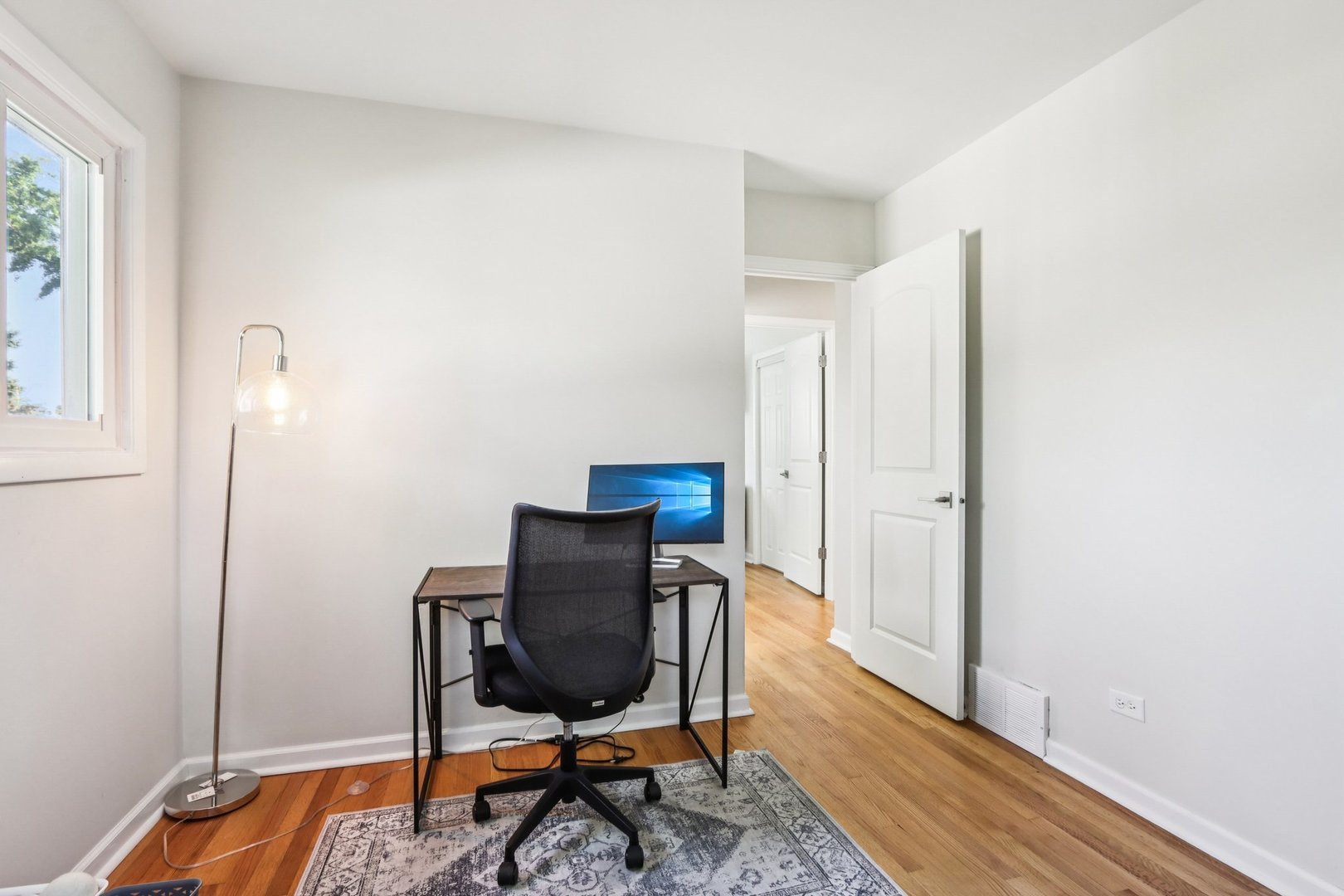 461 Ardmore Terrace Addison, IL 60101 - Photo 9 of 29 a workspace with furniture and wooden floor