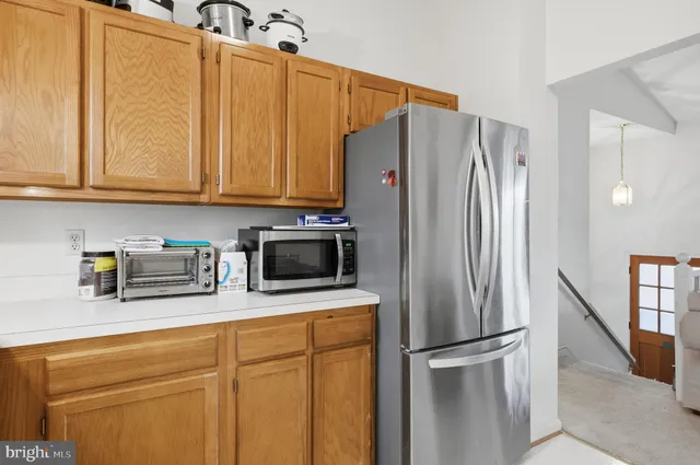 a kitchen with stainless steel appliances a refrigerator sink and cabinets