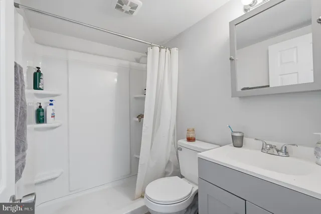a white toilet sitting next to a bathroom sink