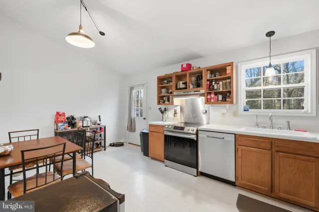 a kitchen that has a sink and a stove