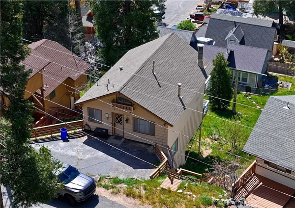 an aerial view of a house with a yard and a garden