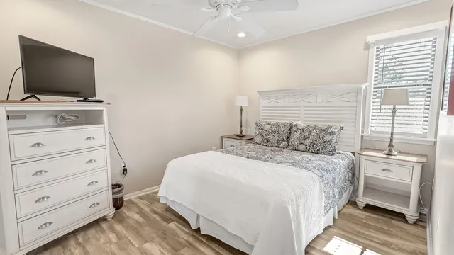 a bedroom with a bed and flat screen tv