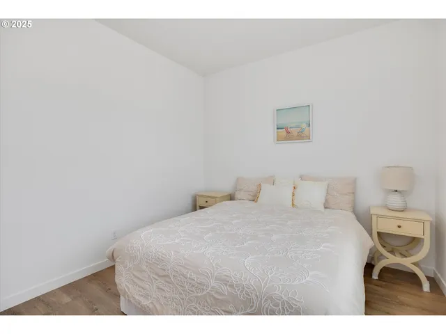 a bedroom with a bed and a night stand