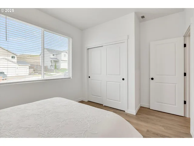 a big room with wooden floor and windows