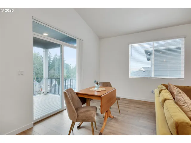 a dining room with furniture and wooden floor