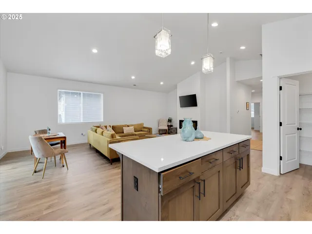 a kitchen with a sink cabinets and wooden floor