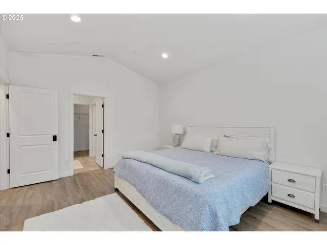 a bedroom with a bed and a night stand