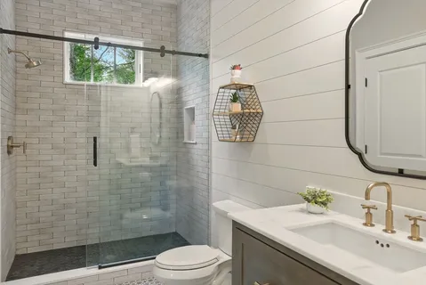 a bathroom with a sink a toilet and shower
