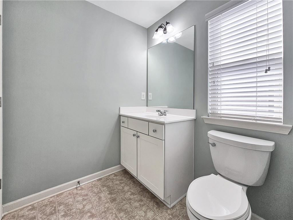 330 Avalon Square Fairburn, GA 30213 - Photo 40 of 52 a bathroom with a toilet sink and mirror