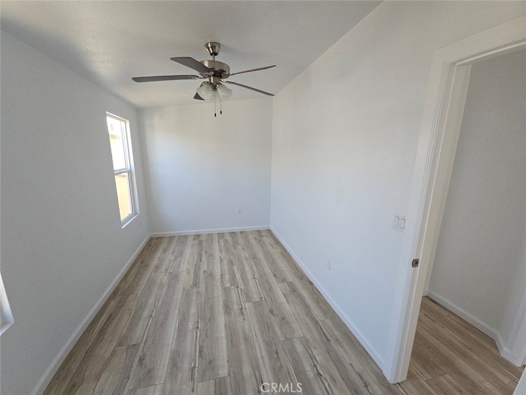 13096 Blackbird Street, Unit 164 Garden Grove, CA 92843 - Photo 16 of 19 wooden floor in an empty room with a window