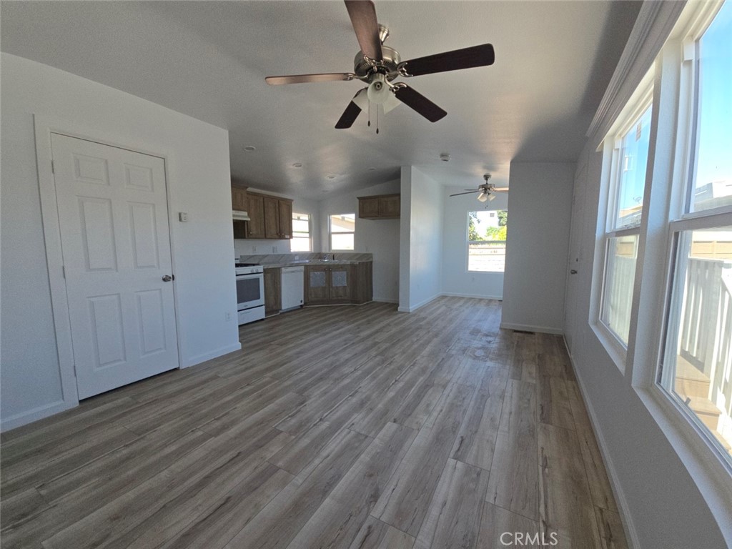 13096 Blackbird Street, Unit 164 Garden Grove, CA 92843 - Photo 8 of 19 a view of empty room with wooden floor and fan