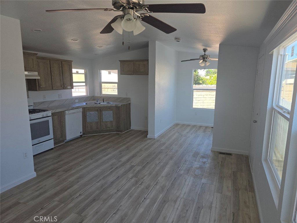 13096 Blackbird Street, Unit 164 Garden Grove, CA 92843 - Photo 9 of 19 a view of a kitchen counter space wooden floor and a ceiling fan