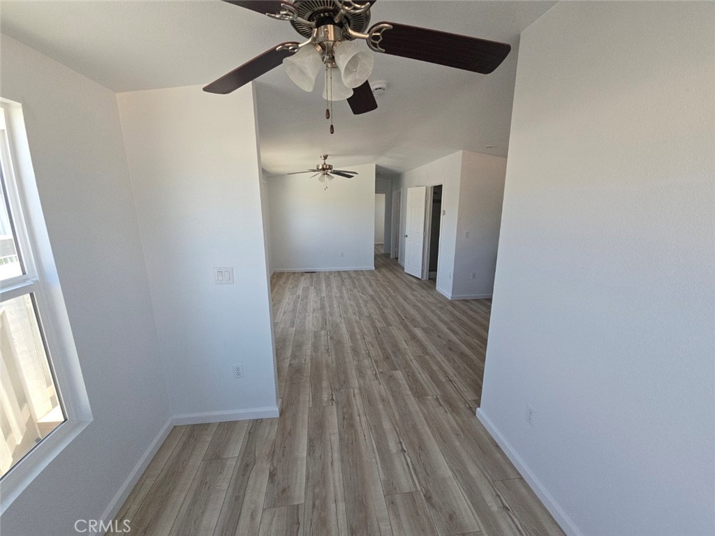 13096 Blackbird Street, Unit 164 Garden Grove, CA 92843 - Photo 10 of 19 wooden floor in an empty room with a window