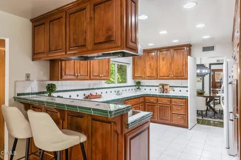 a kitchen with stainless steel appliances granite countertop a stove a sink dishwasher and cabinets with wooden cabinets