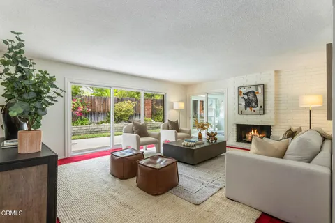 a living room with furniture and a potted plant