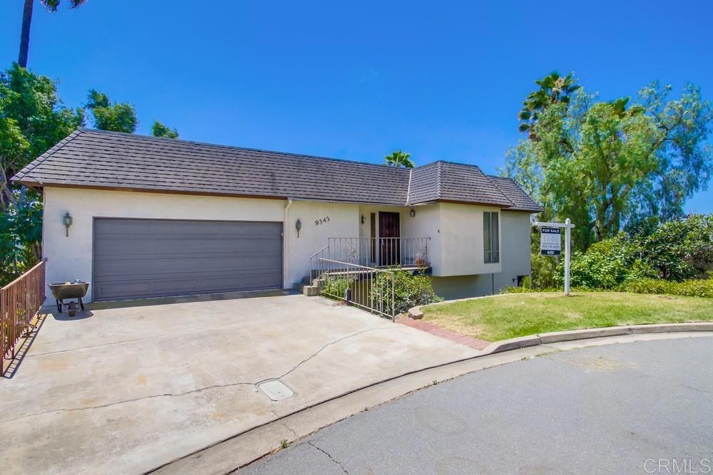 9343 Kahlua Way Spring Valley, CA 91977 - Photo 1 of 1 a front view of a house with a yard and garage