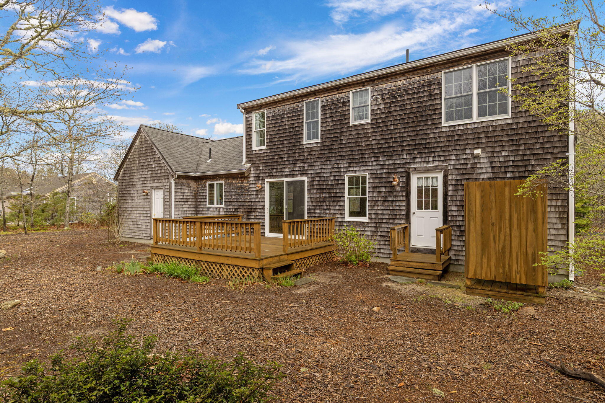 65 Whitney Road Eastham, MA 02642 - Photo 7 of 41 a front view of a house with a garden