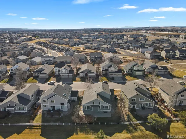 an aerial view of residential building with parking