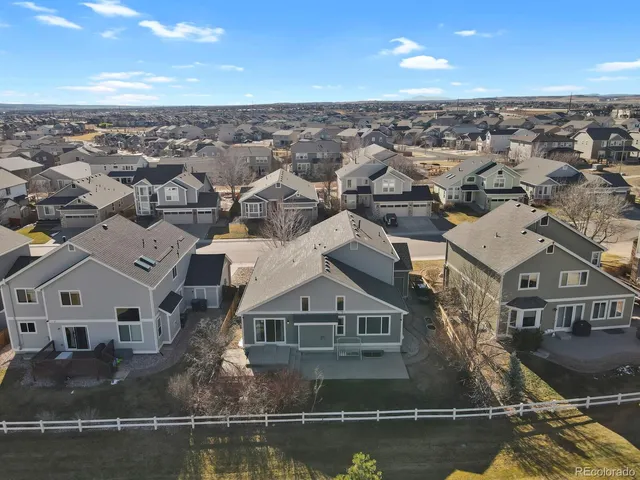 an aerial view of residential houses with city view