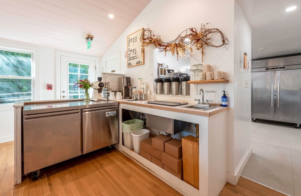 162 Main Street Essex, MA 01929 - Photo 16 of 26 a kitchen with stainless steel appliances a sink a stove and a refrigerator