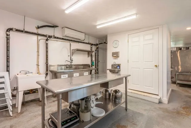 a view of a hallway with two white cabinets