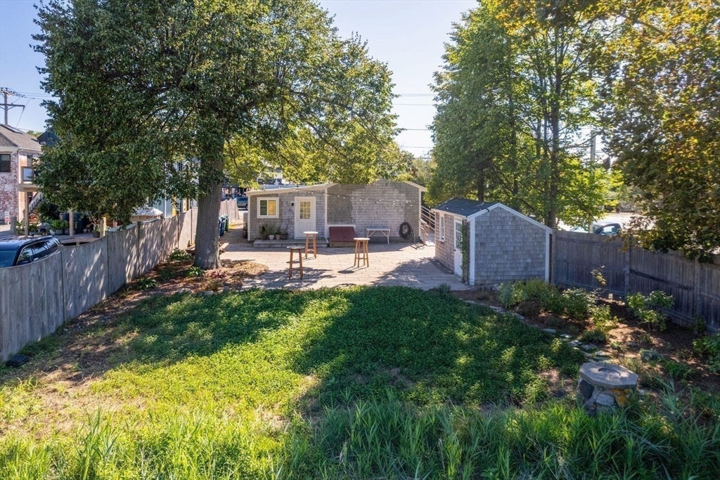 162 Main Street Essex, MA 01929 - Photo 5 of 26 a view of a backyard with plants and a patio