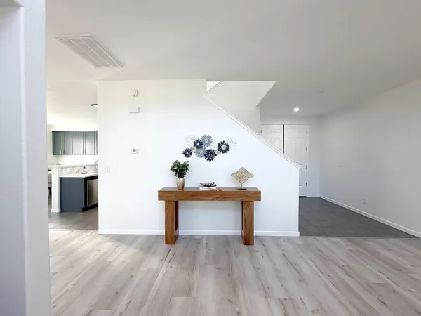a living room with furniture dining table a fireplace and a potted plant