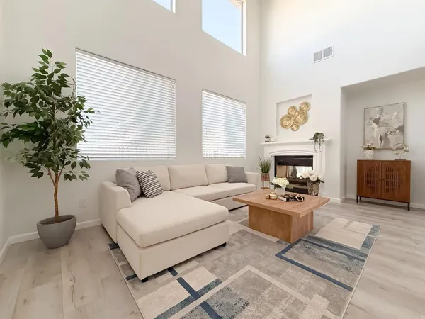 a living room with furniture and wooden floor