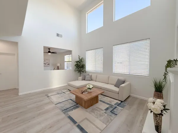 a living room with furniture a window and a flat screen tv