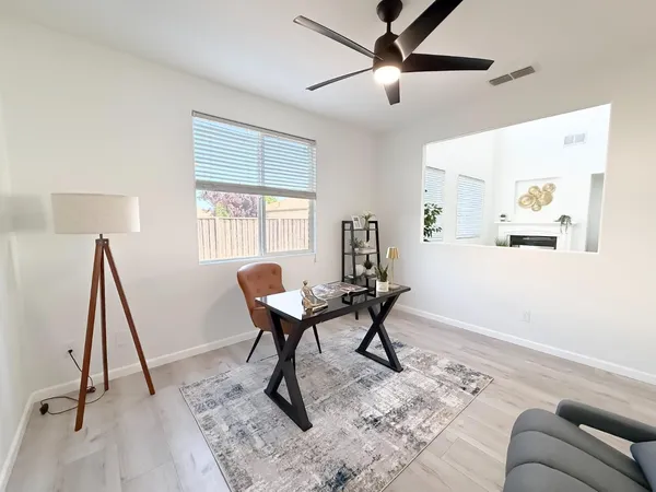 a living room with furniture a fireplace and a potted plant