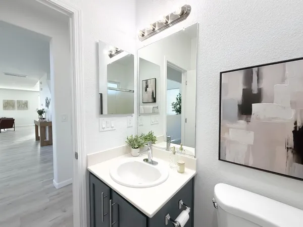a living room with a fireplace and a potted plant