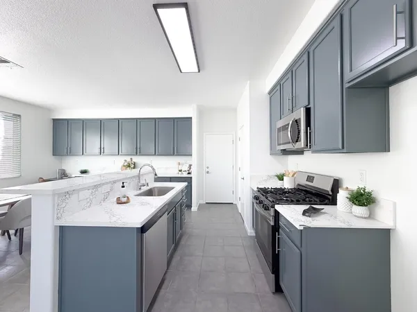 a spacious bedroom with a bed and a ceiling fan