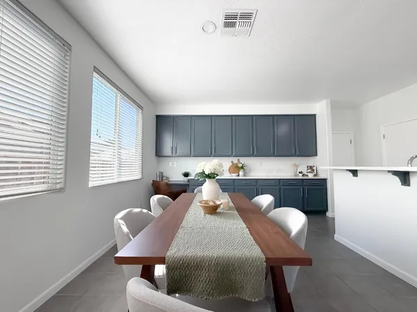 an empty room with windows and ceiling fan