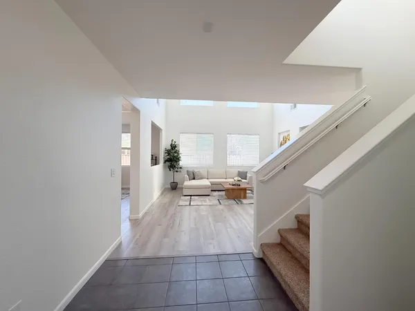 a living room with furniture a fireplace and a potted plant