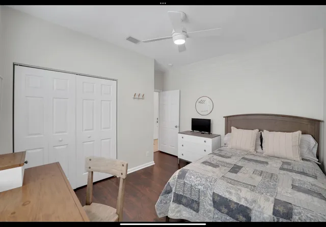 a bedroom with a bed and a table