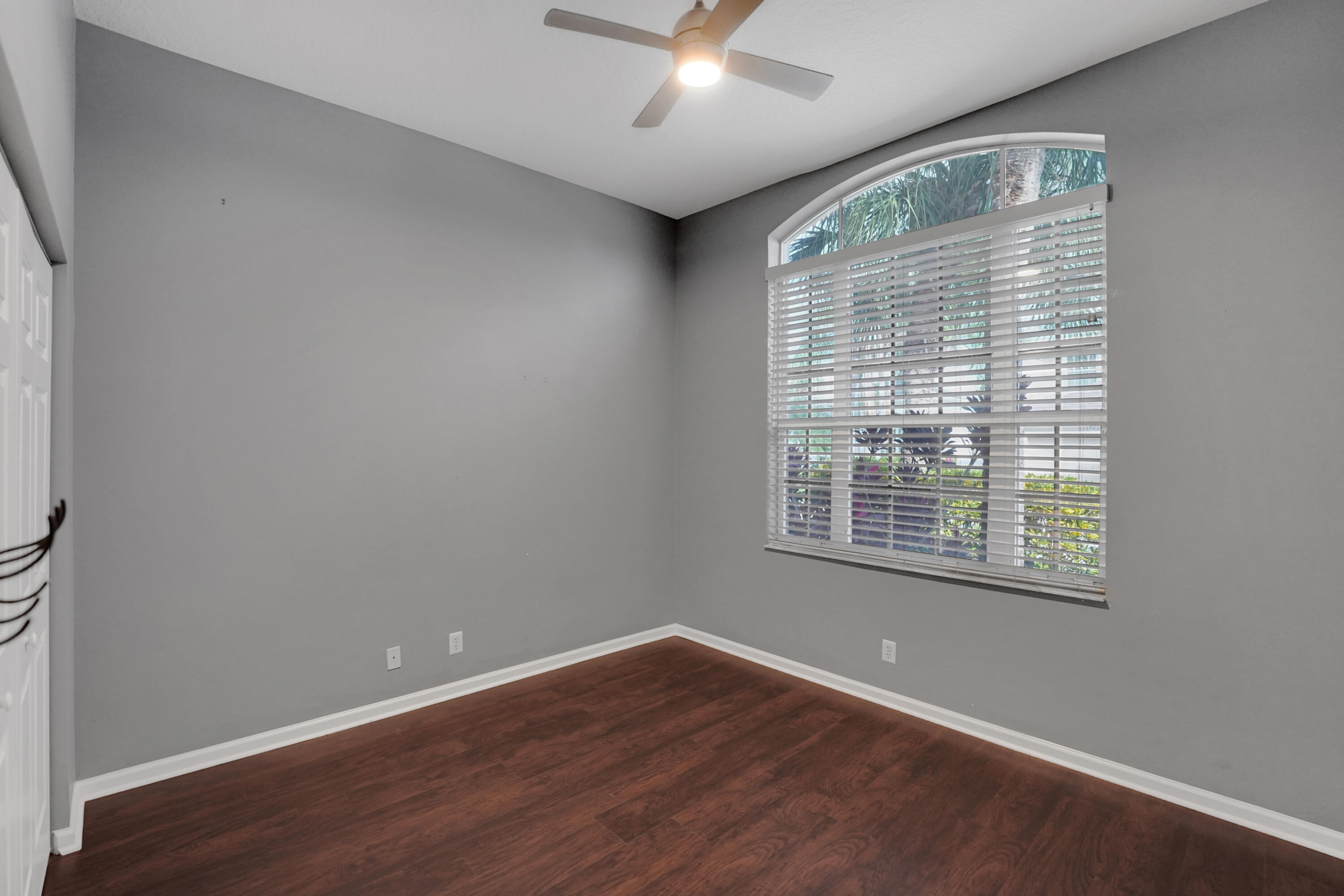 7922 Monarch Court Delray Beach, FL 33446 - Photo 12 of 31 a view of an empty room with wooden floor and a window