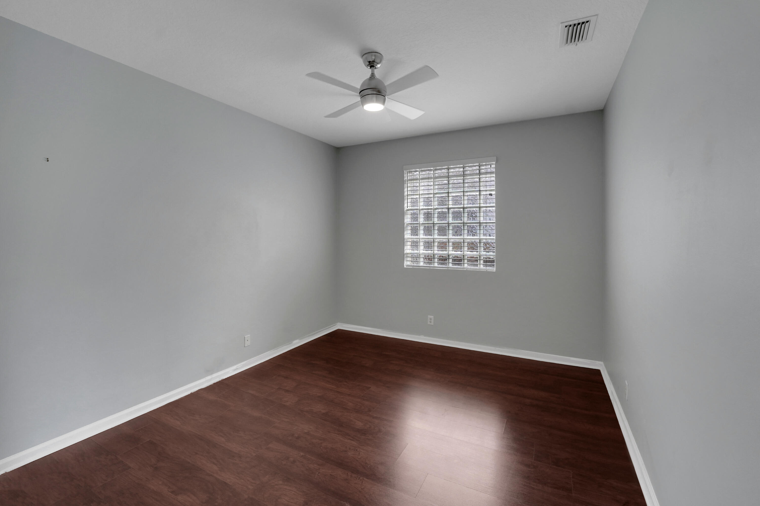 7922 Monarch Court Delray Beach, FL 33446 - Photo 14 of 31 an empty room with wooden floor and windows