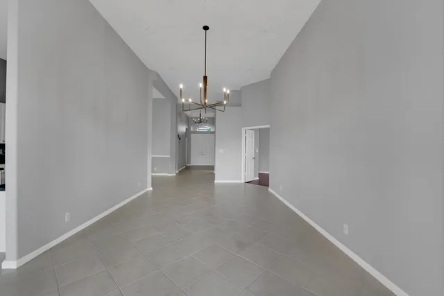 a view of a chandelier and a ceiling fan in a room
