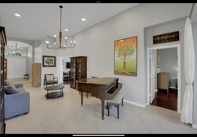 a living room with furniture and a chandelier