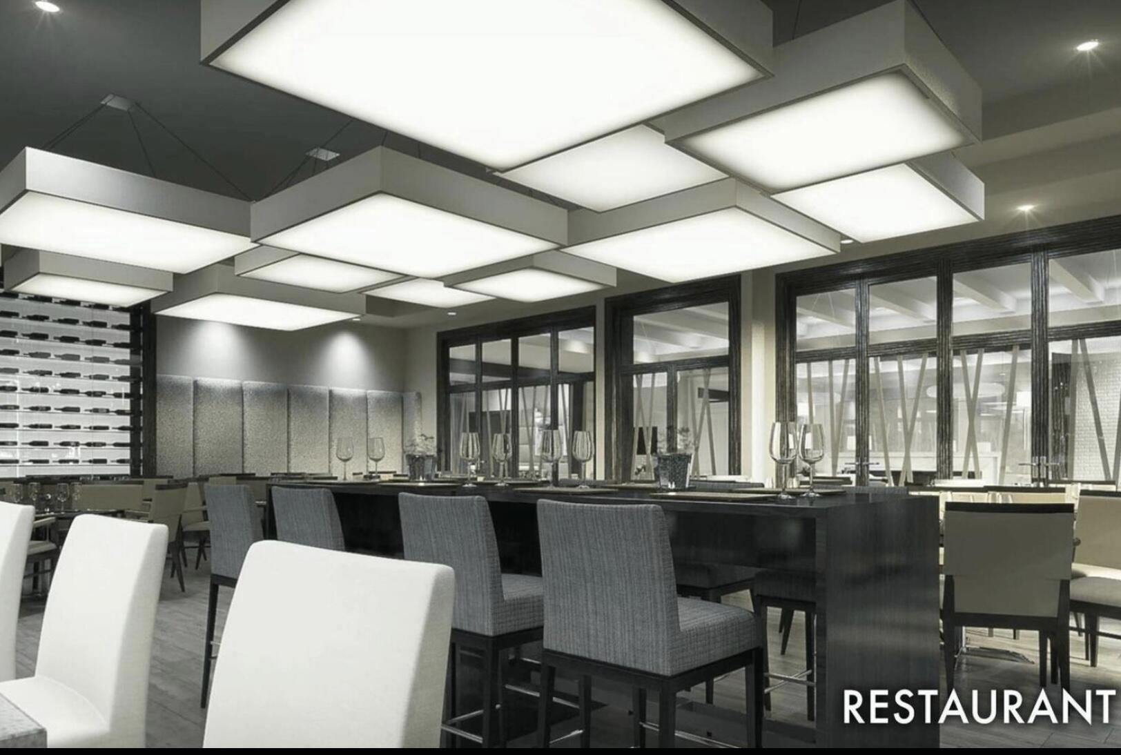 7922 Monarch Court Delray Beach, FL 33446 - Photo 30 of 31 a kitchen with a dining table chairs and granite counter tops