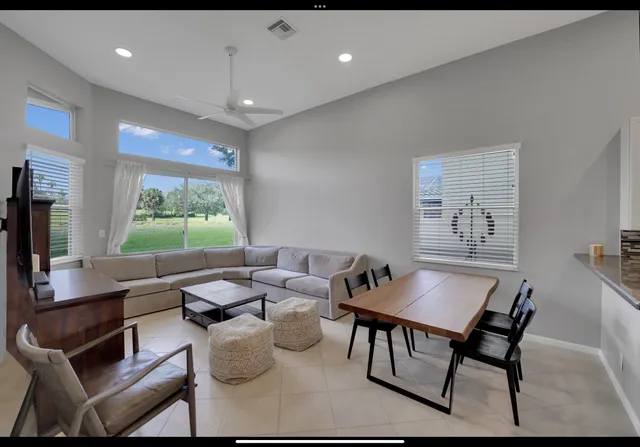 a dining room with furniture and a flat screen tv