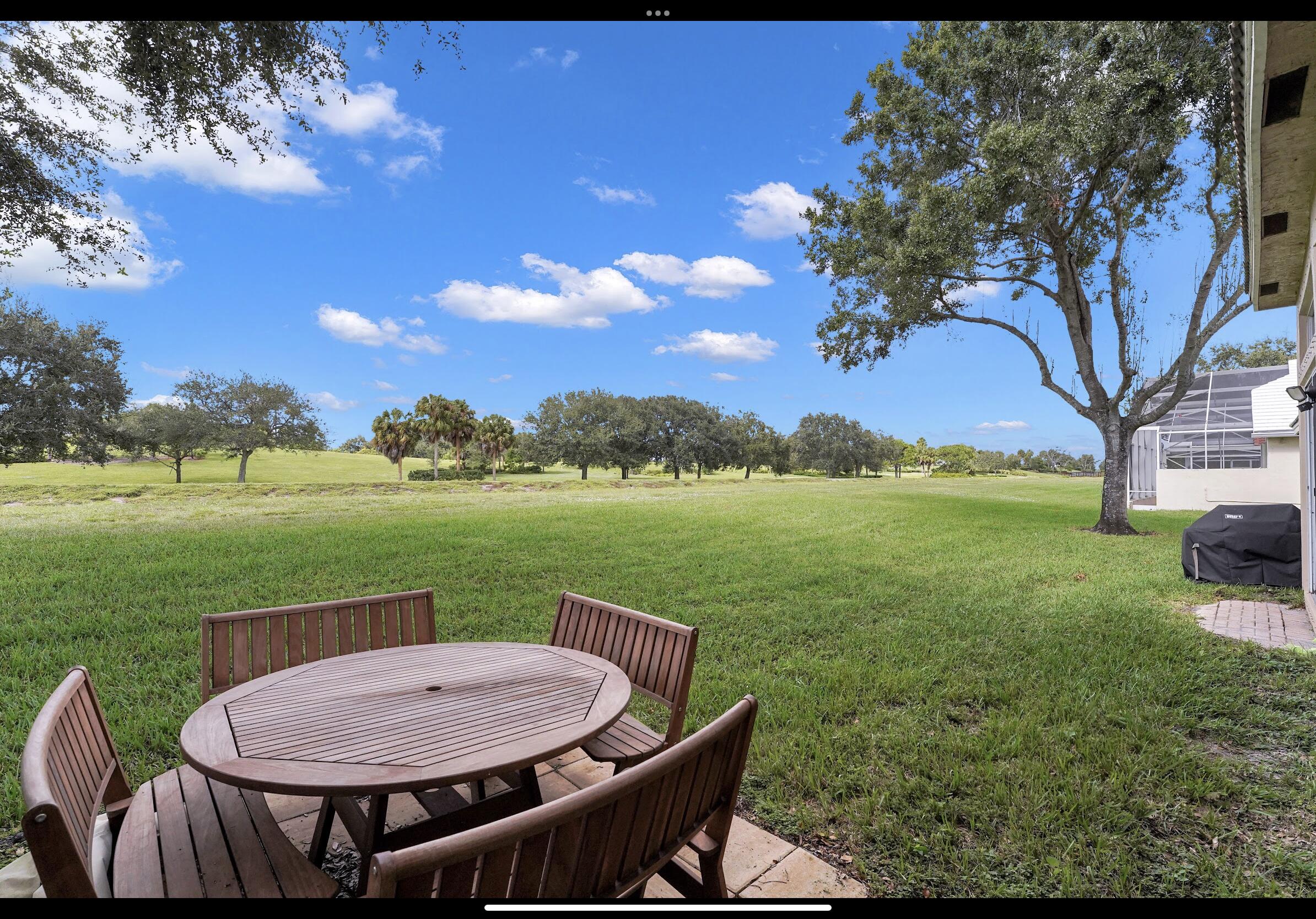 7922 Monarch Court Delray Beach, FL 33446 - Photo 5 of 31 a view of a lake with a table and chairs