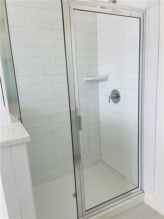 72 Garrison Drive Winder, GA 30680 - Photo 17 of 20 a bathroom with a glass door shower