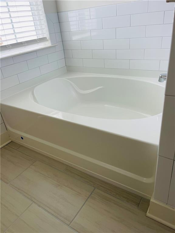 72 Garrison Drive Winder, GA 30680 - Photo 18 of 20 a bathroom with a bathtub