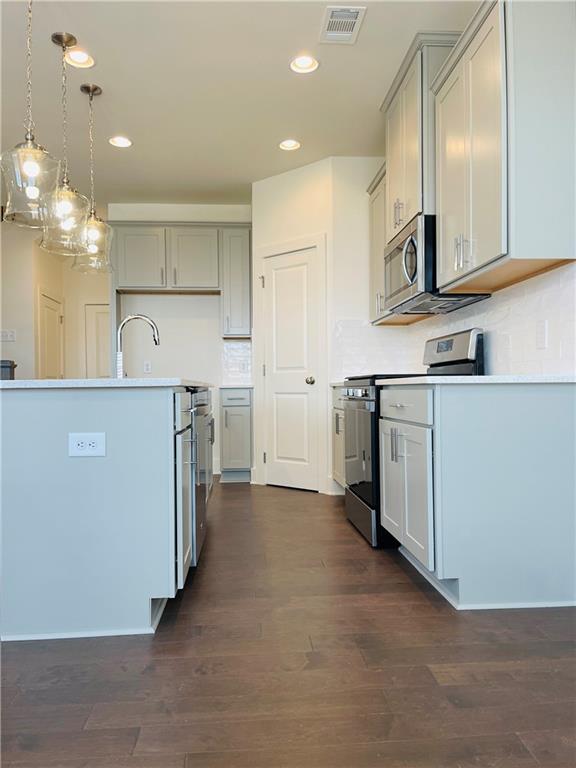72 Garrison Drive Winder, GA 30680 - Photo 5 of 20 a kitchen with cabinets and wooden floor