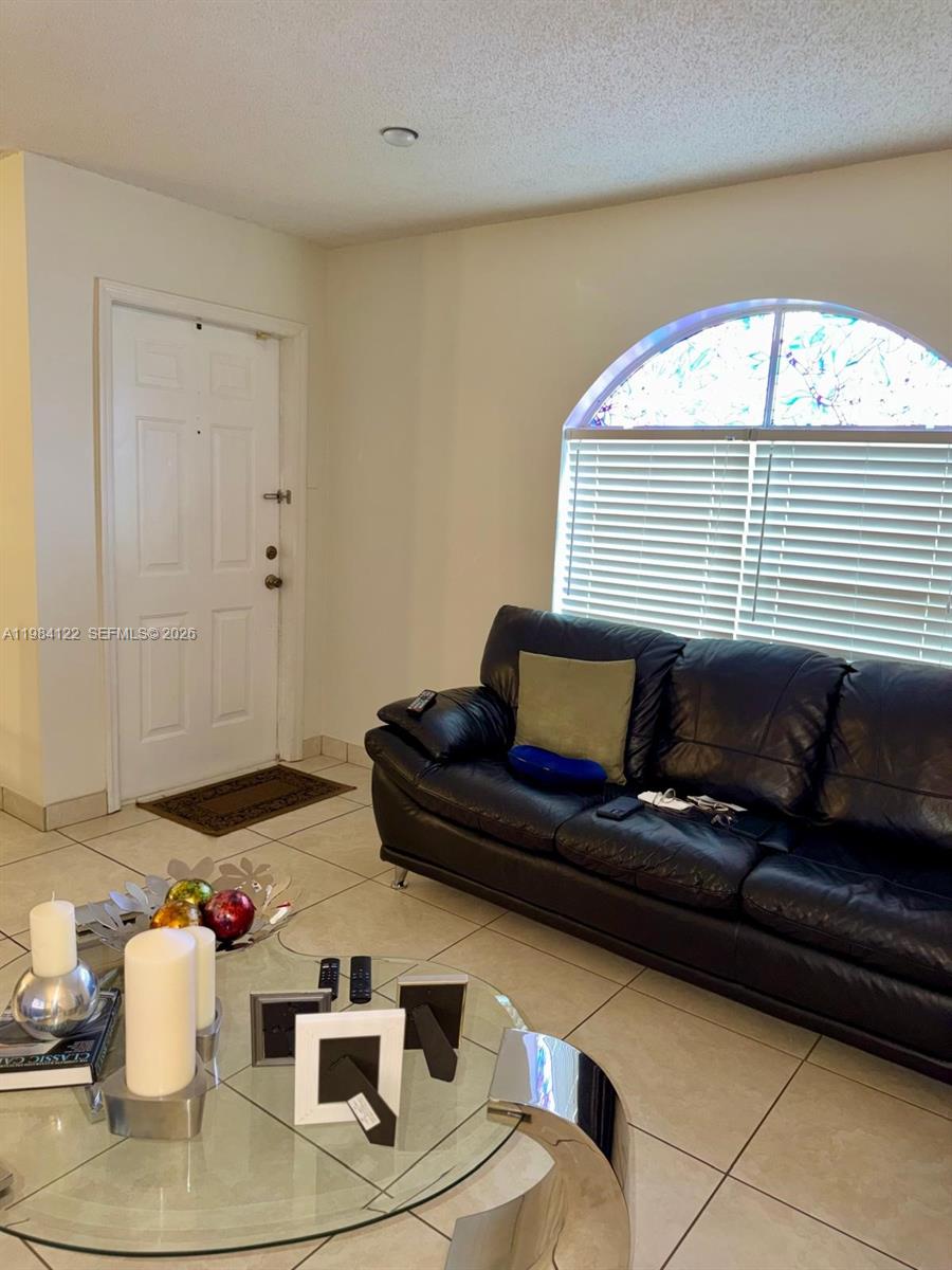 3858 Southwest 153rd Place Miami, FL 33185 - Photo 11 of 37 a living room with a couch and a table