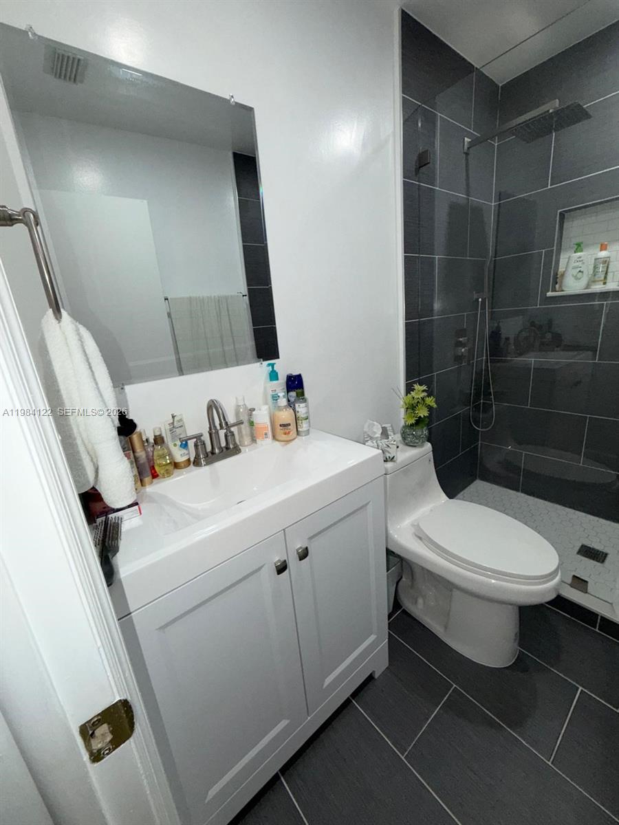 3858 Southwest 153rd Place Miami, FL 33185 - Photo 16 of 37 a bathroom with a toilet sink and shower