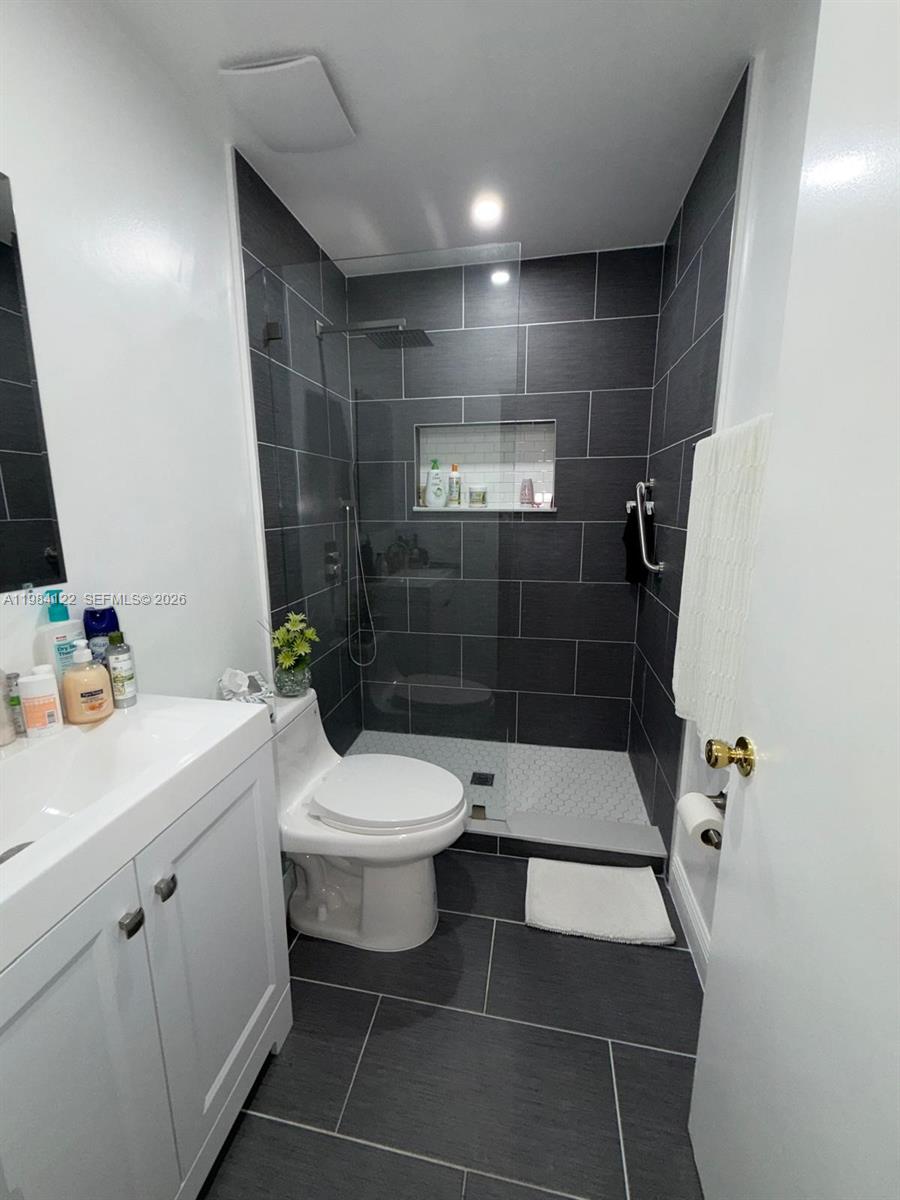 3858 Southwest 153rd Place Miami, FL 33185 - Photo 17 of 37 a bathroom with a sink a toilet and shower