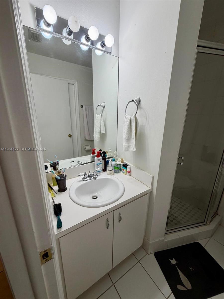 3858 Southwest 153rd Place Miami, FL 33185 - Photo 22 of 37 a bathroom with a sink a toilet and mirror