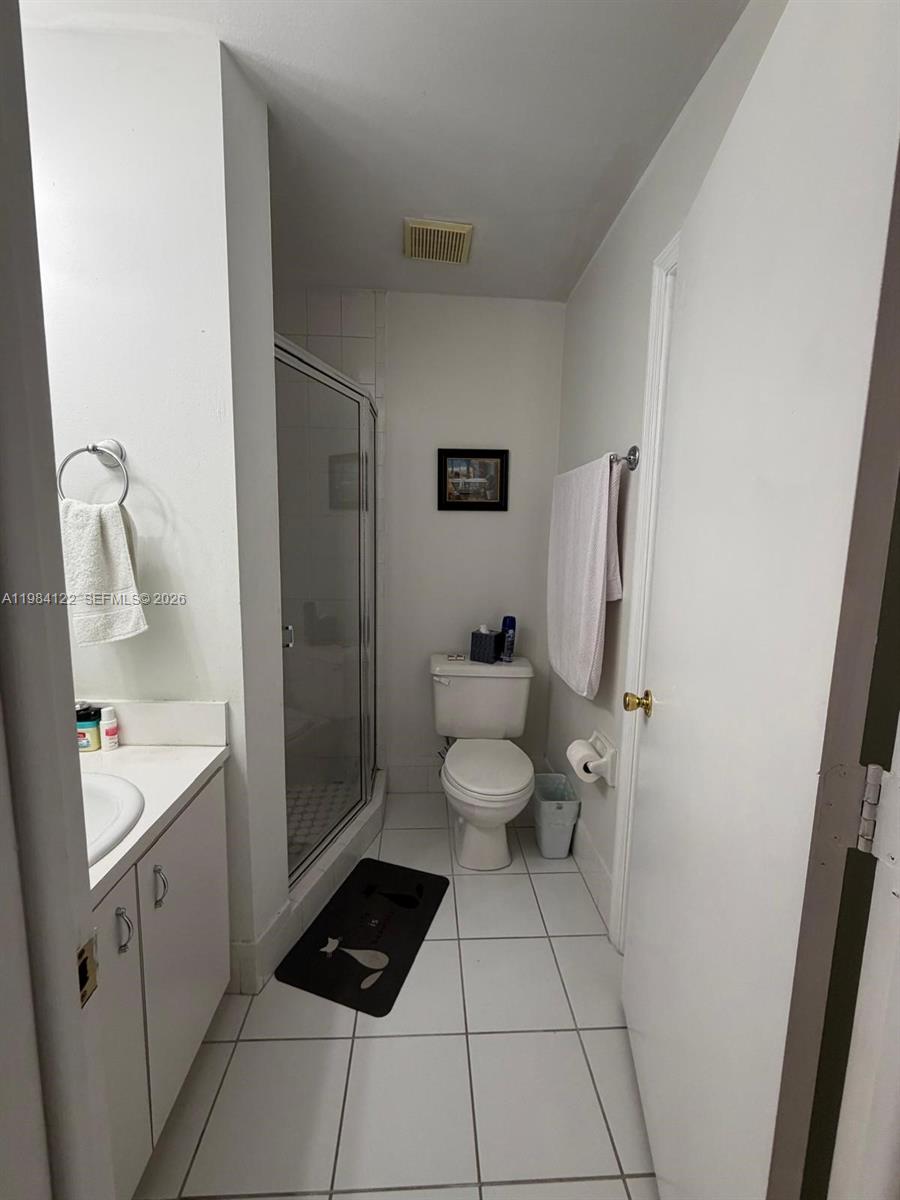 3858 Southwest 153rd Place Miami, FL 33185 - Photo 23 of 37 a bathroom with a sink a toilet and shower